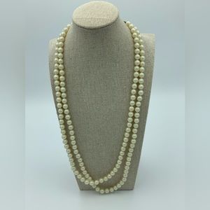 Very long faux pearl necklace